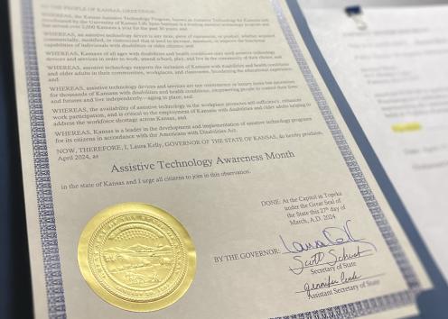 A proclamation with the seal of Kansas designates Assistive Technology Month 